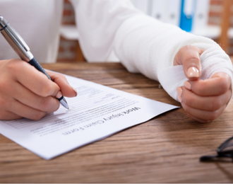 worker with a fractured hand filling out a work injury form