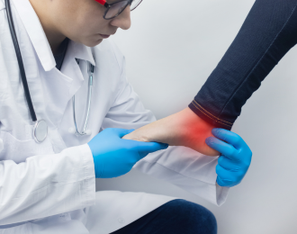 doctor examining an employee suffering from an ankle injury