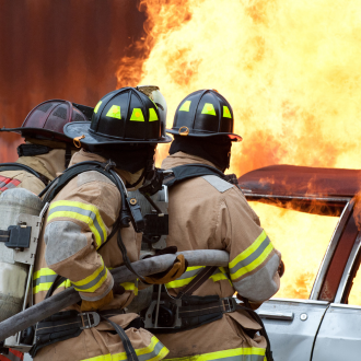 firefighters working on extinguishing a car fire